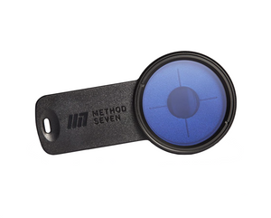 Method Seven Catalyst HPS Phone & Tablet Camera Filter. Black in colour with a high-quality Carl Zeiss lens that balances the color spectrum with insane optical clarity when used under HPS (High Pressure Sodium) lights. The lense has a bluish colour to it in this image, the clip is rectangular in shape.