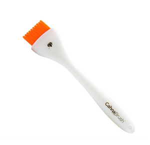 CannaBrush Trimming Brush is designed for trimmers, by trimmers. Brushing is fast and ergonomic. This product has a white base with orange bristles. 