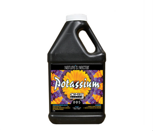 Nature's Nectar Potassium is the leading natural organic nutrient in commercial food and fruit production. This product comes in a black jug, with a top side handle, white lid, with an image of a yellow flower. 